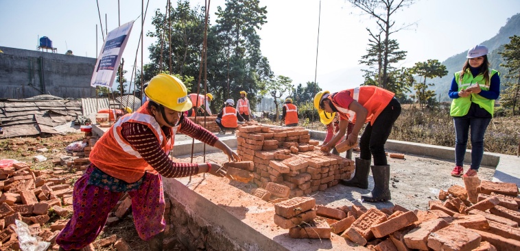 Workers laying bricks on site