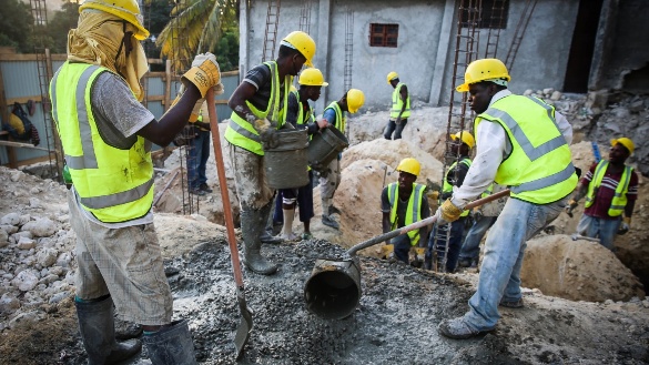Workers pouring concrete on site