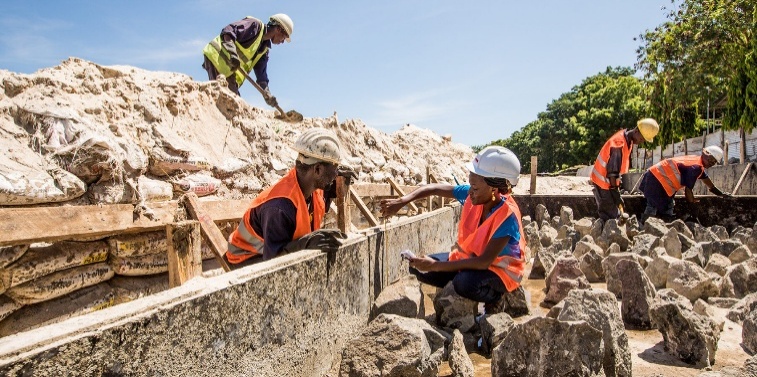 Workers at formwork and sand piles